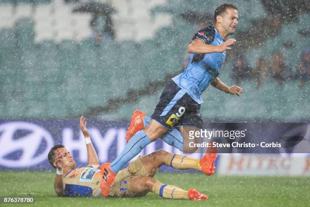 Deyvison Rogério da Silva, Bobô of the Sydney FC goes flying over Jets Daniel Georgievski in the pouring rain during the round seven A-League match...
