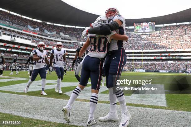 Danny Amendola of the New England Patriots celebrates with Rob Gronkowski after a touchdown against the Oakland Raiders during the first half at...