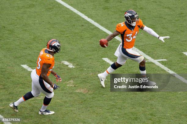 Defensive back Will Parks of the Denver Broncos celebrates after recovering a blocked punt in the first quarter of a game against the Cincinnati...
