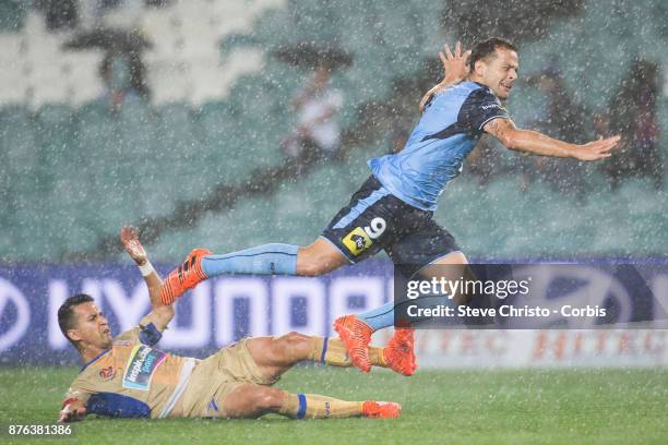 Deyvison Rogério da Silva, Bobô of the Sydney FC goes flying over Jets Daniel Georgievski in the pouring rain during the round seven A-League match...