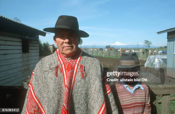 CHILE - NATIVE MAPUCHE FATHER AND SON WITH OSORNO VOLCANO IN BACKGROUND CDREF00797