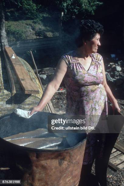 CHILE - WOMAN SMOKING TROUT FROM THE SOUTHERN LAKES CDREF00797