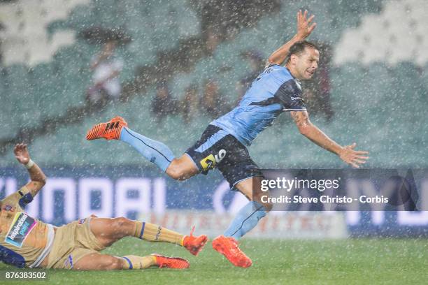 Deyvison Rogério da Silva, Bobô of the Sydney FC goes flying over Jets Daniel Georgievski in the pouring rain during the round seven A-League match...