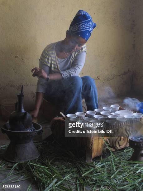 Young woman performing a traditional coffee ceremony in a village in Ethiopia