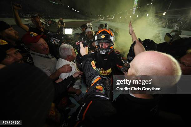 Martin Truex Jr., driver of the Bass Pro Shops/Tracker Boats Toyota, celebrates with teammates after he won the Monster Energy NASCAR Cup Series...