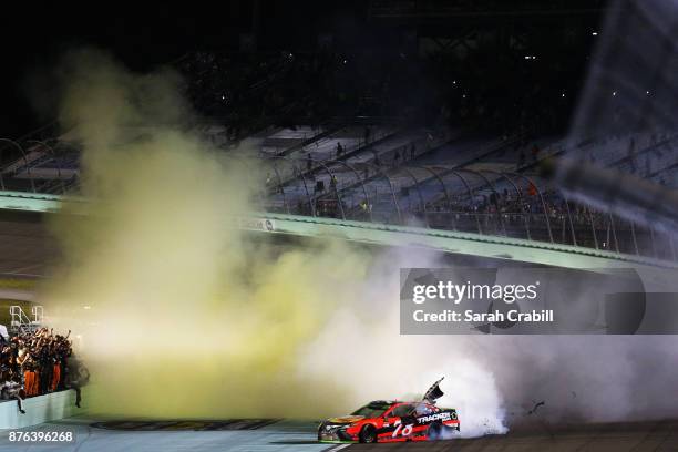 Martin Truex Jr., driver of the Bass Pro Shops/Tracker Boats Toyota, celebrates with a burnout after winning the Monster Energy NASCAR Cup Series...