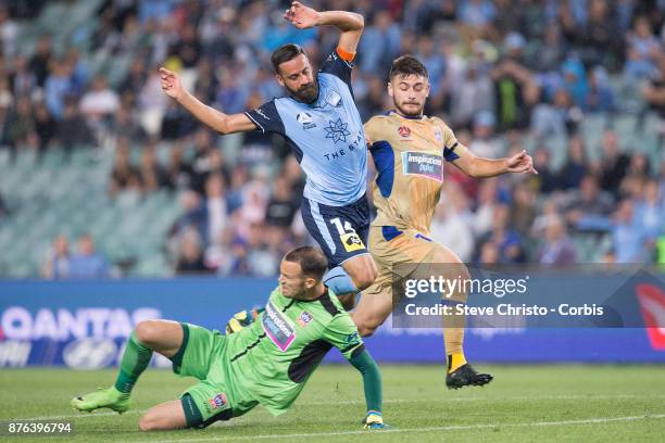 Alex Brosque of the Sydney FC challenges Jets Ivan Vujica and goalkeeper Jack Duncan for the ball during the round seven A-League match between...