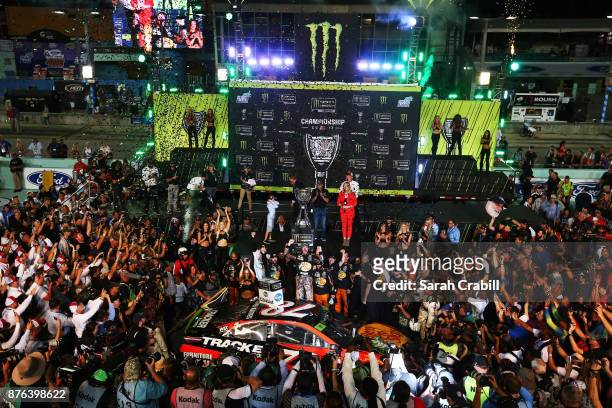 Martin Truex Jr., driver of the Bass Pro Shops/Tracker Boats Toyota, celebrates in Victory Lane after winning the Monster Energy NASCAR Cup Series...