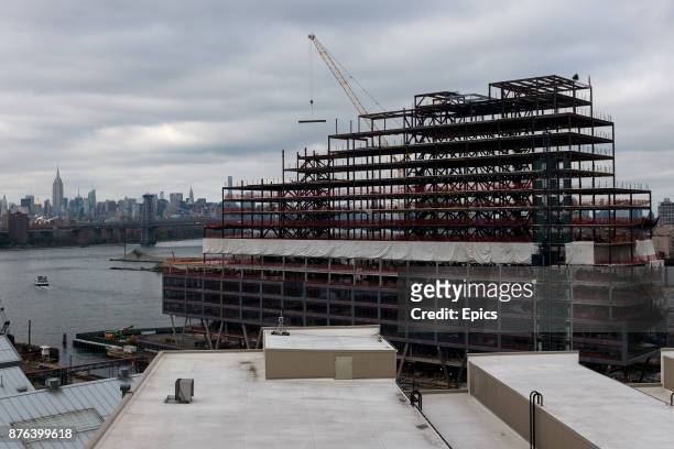 Construction underway at the Brooklyn Navy Yard - The Navy Yard once a shipyard producing warships for the United States Navy and decommissioned in...