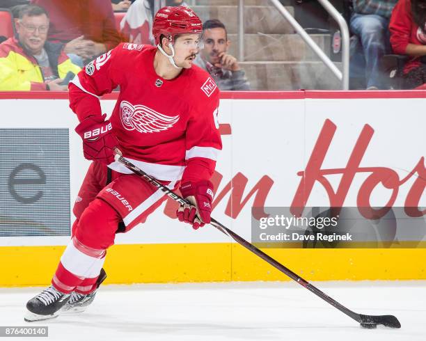 Xavier Ouellet of the Detroit Red Wings turns up ice with the puck against the Buffalo Sabres during an NHL game at Little Caesars Arena on November...