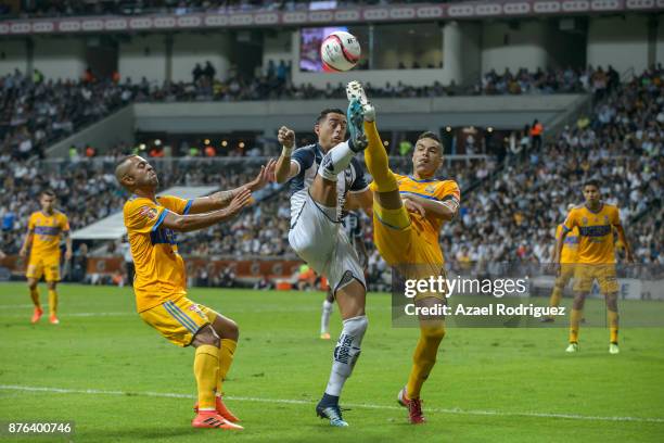 Rogelio Funes Mori of Monterrey fights for the ball with Juninho and Rafael De Souza of Tigres during the 17th round match between Monterrey and...