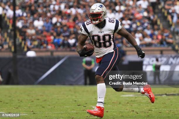 Martellus Bennett of the New England Patriots runs with the ball after a reception against the Oakland Raiders during the second half at Estadio...