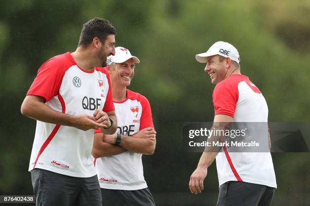 Swans assistant coaches Steve Johnson, Brett Kirk and Dean Cox laugh during a Sydney Swans AFL pre-season training session at Sydney Grammar on...