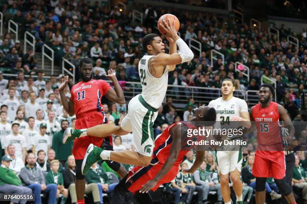 Miles Bridges of the Michigan State Spartans draws a blocking foul from Tyrell Sturdivant of the Stony Brook Seawolves at Breslin Center on November...