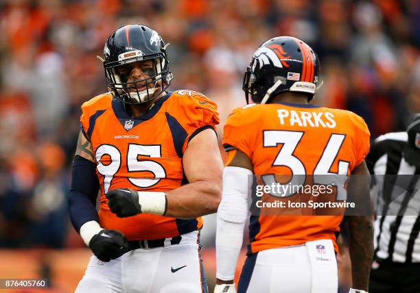 Denver Broncos defensive end Derek Wolfe and Denver Broncos saftey Will Parks celebrate a sack during the first half of a game between the Denver...