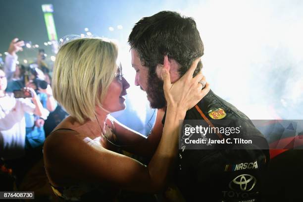 Martin Truex Jr., driver of the Bass Pro Shops/Tracker Boats Toyota, celebrates with girlfriend Sherry Pollex after he won the Monster Energy NASCAR...