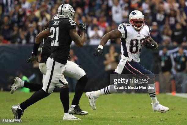 Dwayne Allen of the New England Patriots runs with the ball after a reception against the Oakland Raiders during the second half at Estadio Azteca on...