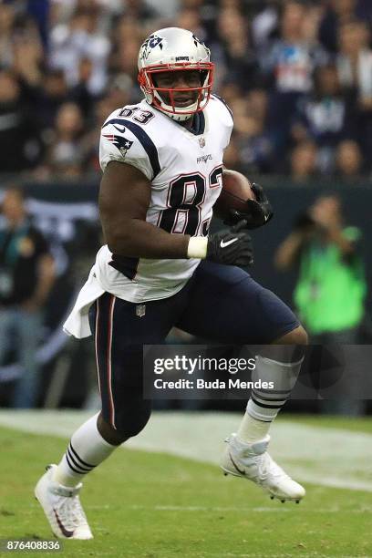 Dwayne Allen of the New England Patriots runs with the ball after a reception against the Oakland Raiders during the second half at Estadio Azteca on...