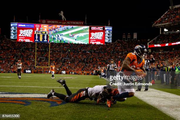 Wide receiver Demaryius Thomas of the Denver Broncos has a fourth quarter touchdown catch under coverage by cornerback Dre Kirkpatrick of the...