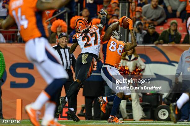 Wide receiver Demaryius Thomas of the Denver Broncos makes a fourth quarter touchdown catch under coverage by cornerback Dre Kirkpatrick of the...