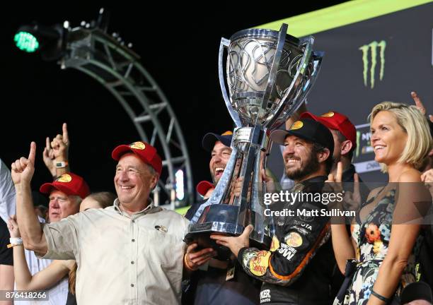 Martin Truex Jr., driver of the Bass Pro Shops/Tracker Boats Toyota, celebrates in Victory Lane after winning the Monster Energy NASCAR Cup Series...