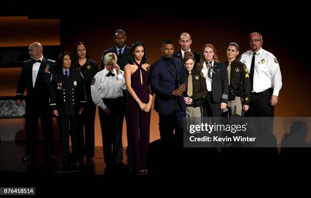 Corinne Foxx and Jamie Foxx and first responders pose onstage during the 2017 American Music Awards at Microsoft Theater on November 19, 2017 in Los...