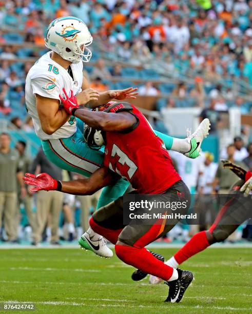 Miami Dolphins kicker Matt Haack is hit by Tampa Bay Buccaneers' Adarius Glanton on Sunday, Nov. 19, 2017 at Hard Rock Stadium in Miami Gardens, Fla.