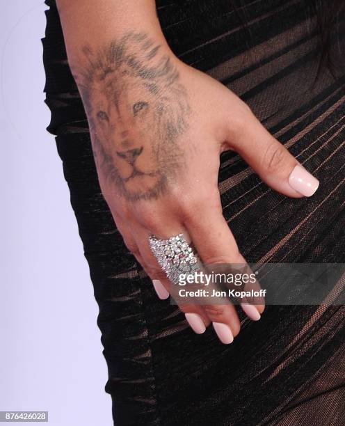 Demi Lovato, jewelry detail, attends the 2017 American Music Awards at Microsoft Theater on November 19, 2017 in Los Angeles, California.