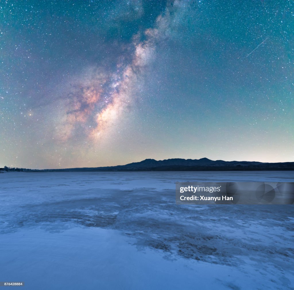 Starry night over snow covered landscape