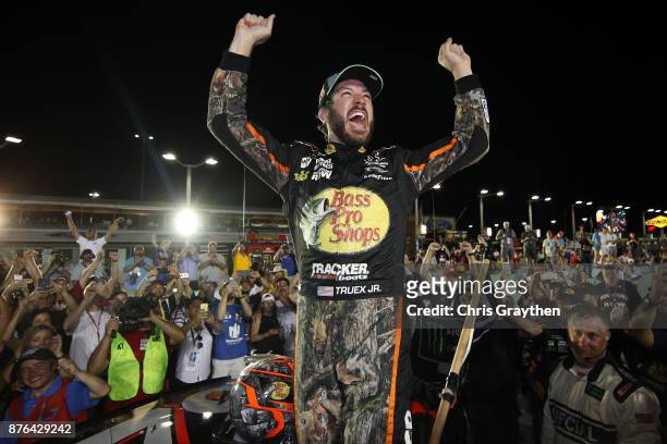 Martin Truex Jr., driver of the Bass Pro Shops/Tracker Boats Toyota, celebrates after winning the Monster Energy NASCAR Cup Series Championship and...