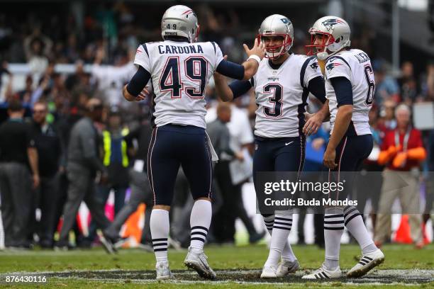 Stephen Gostkowski of the New England Patriots celebrates with Joe Cardona and Ryan Allen after kicking a field goal against the Oakland Raiders...