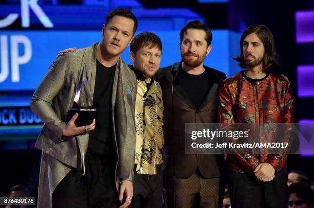 Dan Reynolds, Ben McKee, Daniel Platzman and Daniel Wayne Sermon of Imagine Dragons on stage at the 2017 American Music Awards at Microsoft Theater...