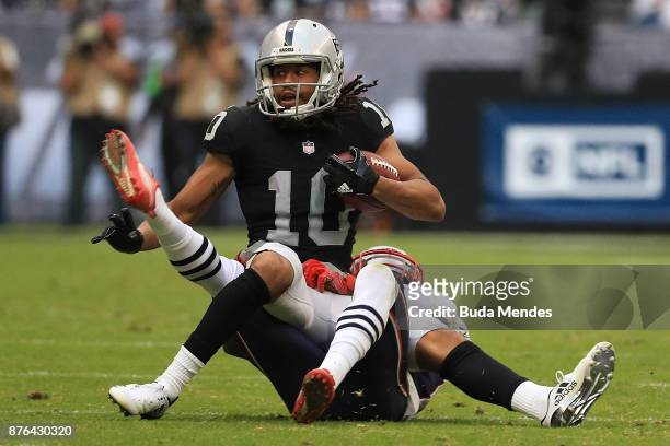 Seth Roberts of the Oakland Raiders attempts to break a tackle from Jonathan Jones of the New England Patriots during the first half at Estadio...