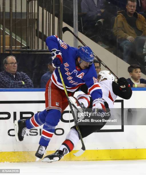 Marc Staal of the New York Rangers steps into Jean-Gabriel Pageau of the Ottawa Senators during the third period at Madison Square Garden on November...