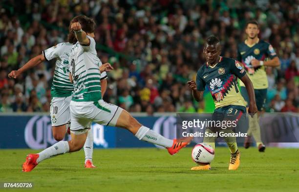 Darwin Quintero of America fights for the ball with Jose Abella of Santos during the 17th round match between Santos Laguna and America as part of...