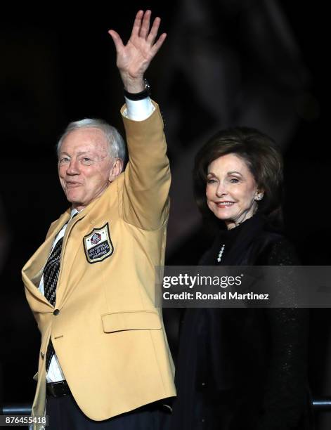 Dallas Cowboys owner Jerry Jones waves to the crowd as he and his wife Gene take the stage before the Pro Football Hall of Fame ring ceremony during...