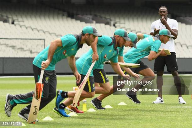 Usain Bolt coaches Australian cricketers Glenn Maxwell, Ashton Agar, Peter Handscomb and Aaron Finch during the Gatorade Fastest Run at the Melbourne...