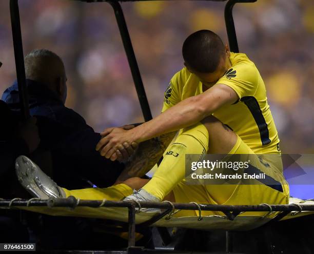 Dario Benedetto of Boca Juniors leaves the field after being injured during a match between Boca Juniors and Racing Club as part of the Superliga...