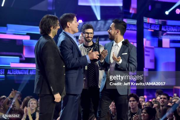 Rob Bourdon, Mike Shinoda, and Brad Delson of the band Linkin Park accept award onstage during the 2017 American Music Awards at Microsoft Theater on...