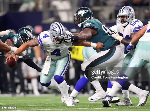 Dak Prescott of the Dallas Cowboys gets his facemask grabbed by Fletcher Cox of the Philadelphia Eagles in the fourth quarter of a football game at...