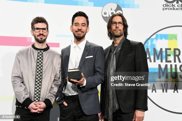 Brad Delson, Mike Shinoda and Rob Bourdon of Linkin Park pose in the press room during the 2017 American Music Awards at Microsoft Theater on...