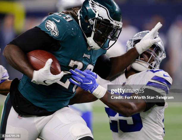 Philadelphia Eagles running back LeGarrette Blount runs through a tackle by Dallas Cowboys safety Xavier Woods in the fourth quarter on Sunday, Nov....