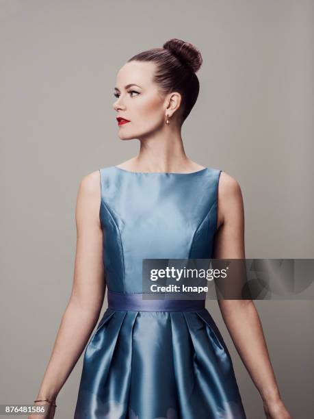 retro styled woman with make-up red lips and eyeliner in 60s dress - blue dress stock pictures, royalty-free photos & images