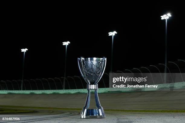 Martin Truex Jr., driver of the Bass Pro Shops/Tracker Boats Toyota, poses with the Monster Energy NASCAR Cup Series championship trophy after...