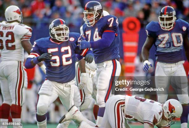 Linebacker Pepper Johnson and defensive lineman Erik Howard of the New York Giants celebrate after a sack of quarterback Neil Lomax of the St. Louis...