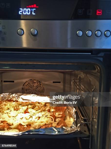 tenderized beef with lots of onion in the electric oven - tenderizer stock pictures, royalty-free photos & images