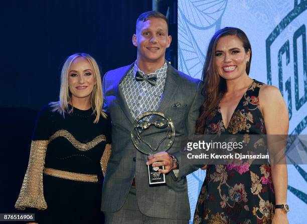 Caeleb Dressel winner of Male Athlete of the Year poses with presenters Nastia Liukin and Natalie Coughlin during the 2017 USA Swimming Golden Goggle...