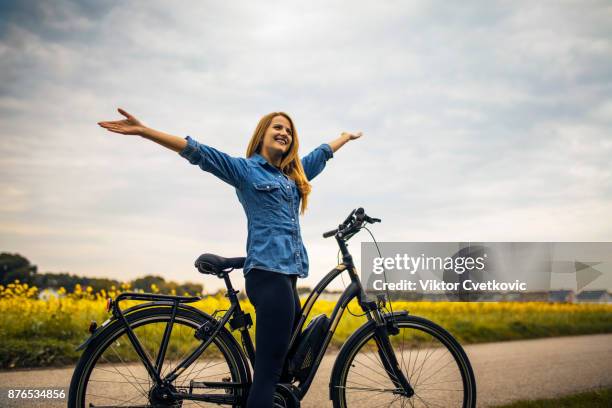 woman riding on her electric bike - battery life stock pictures, royalty-free photos & images