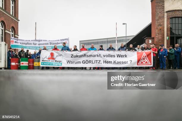 Workers protest in front of the steam turbine factory of Siemens on November 17, 2017 in Goerlitz, Germany. The concern announced to close the...