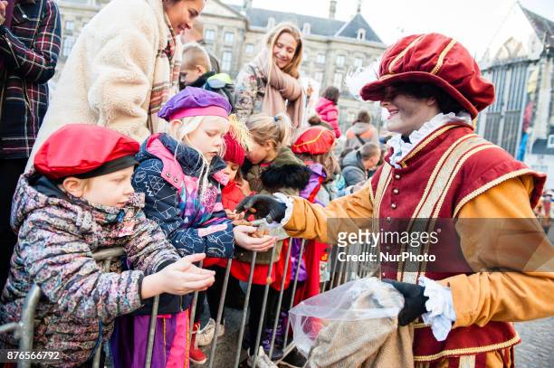 People attend the Saint Nicholas parade, in Amsterdam, Netherlands, on November 19, 2017. With more than a kilometre of floats and boats, Amsterdam...